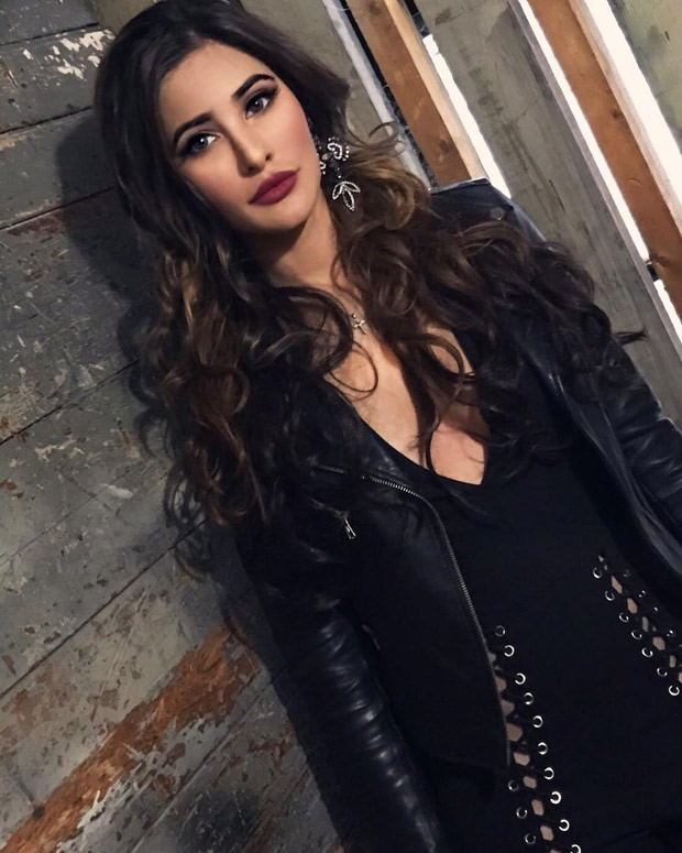 HOT! Nargis Fakhri sizzles in a brown dress with a plunging neck line