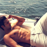 Varun Dhawan poses shirtless on a boat in the middle of the sea; Katrina Kaif reacts