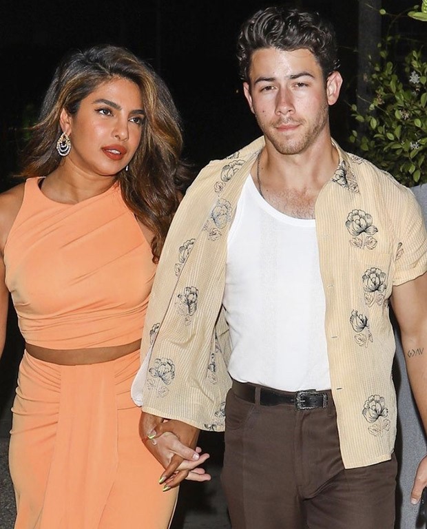 Priyanka Chopra in a salmon crop top and skirt and Nick Jonas in a tank top and an unbuttoned shirt spotted holding hands post dinner date
