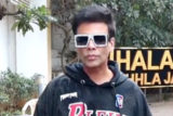 Karan Johar poses for paps in a hoodie and funky glasses